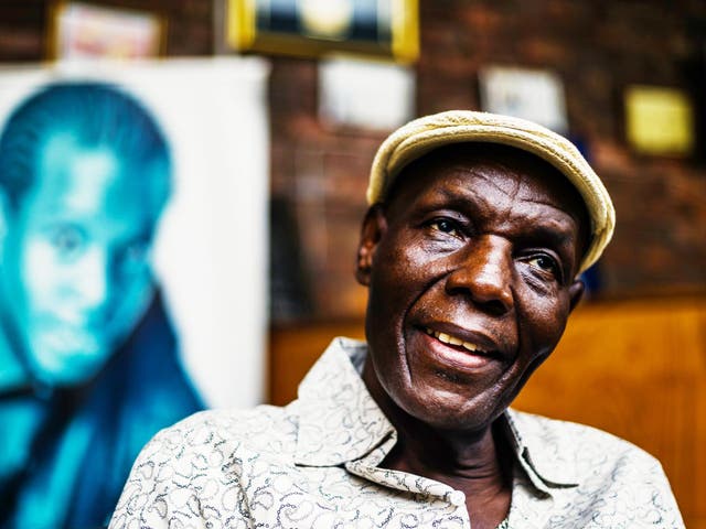 ‘Tuku’ in January last year in front of a picture of his late son