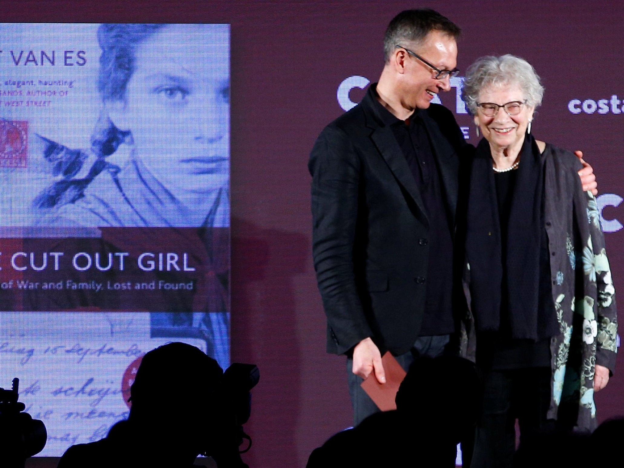 Bart van Es, author of the book 'The Cut Out Girl', embraces the subject of his book Lien de Jong during the Costa Book of the Year Award ceremony in London