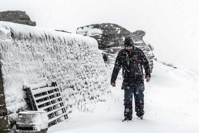 A man walks in snowy conditions at the Tan Hill Inn in North Yorkshire; up to 10cm of snow could fall on higher ground as temperatures drop across large parts of the UK this week