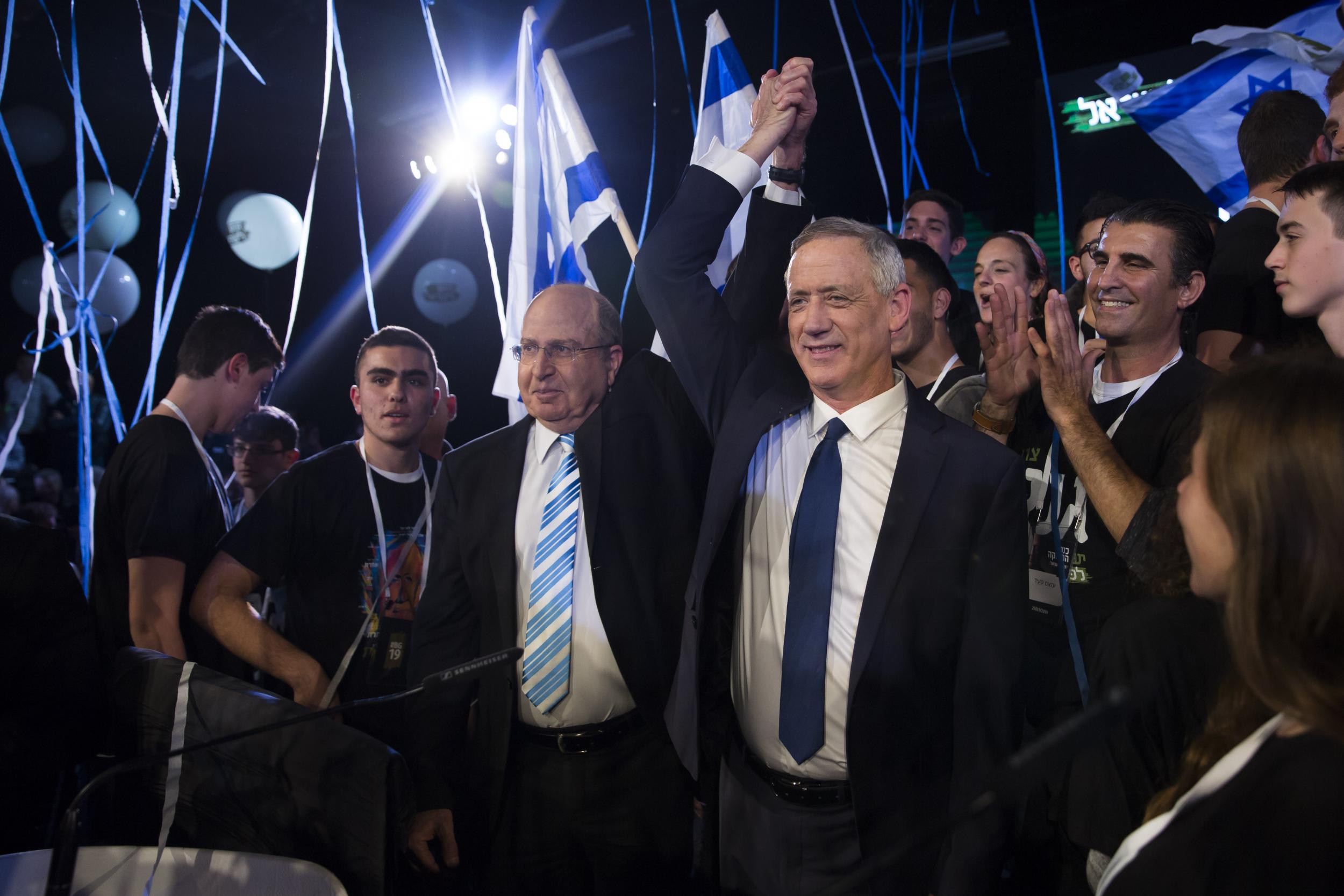 Benny Gantz (right) former minister of defence Moshe Ya’alon gesture supporters during a campaign event (Getty)