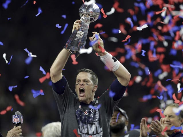 New England Patriots' Tom Brady raises the Vince Lombardi Trophy