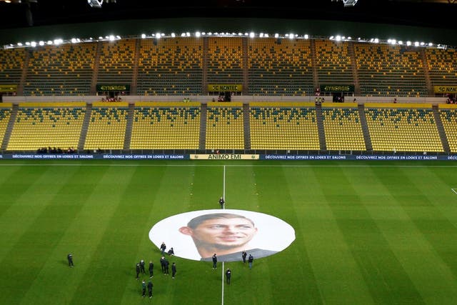 An image of Emiliano Sala is unfurled on the pitch in Nantes