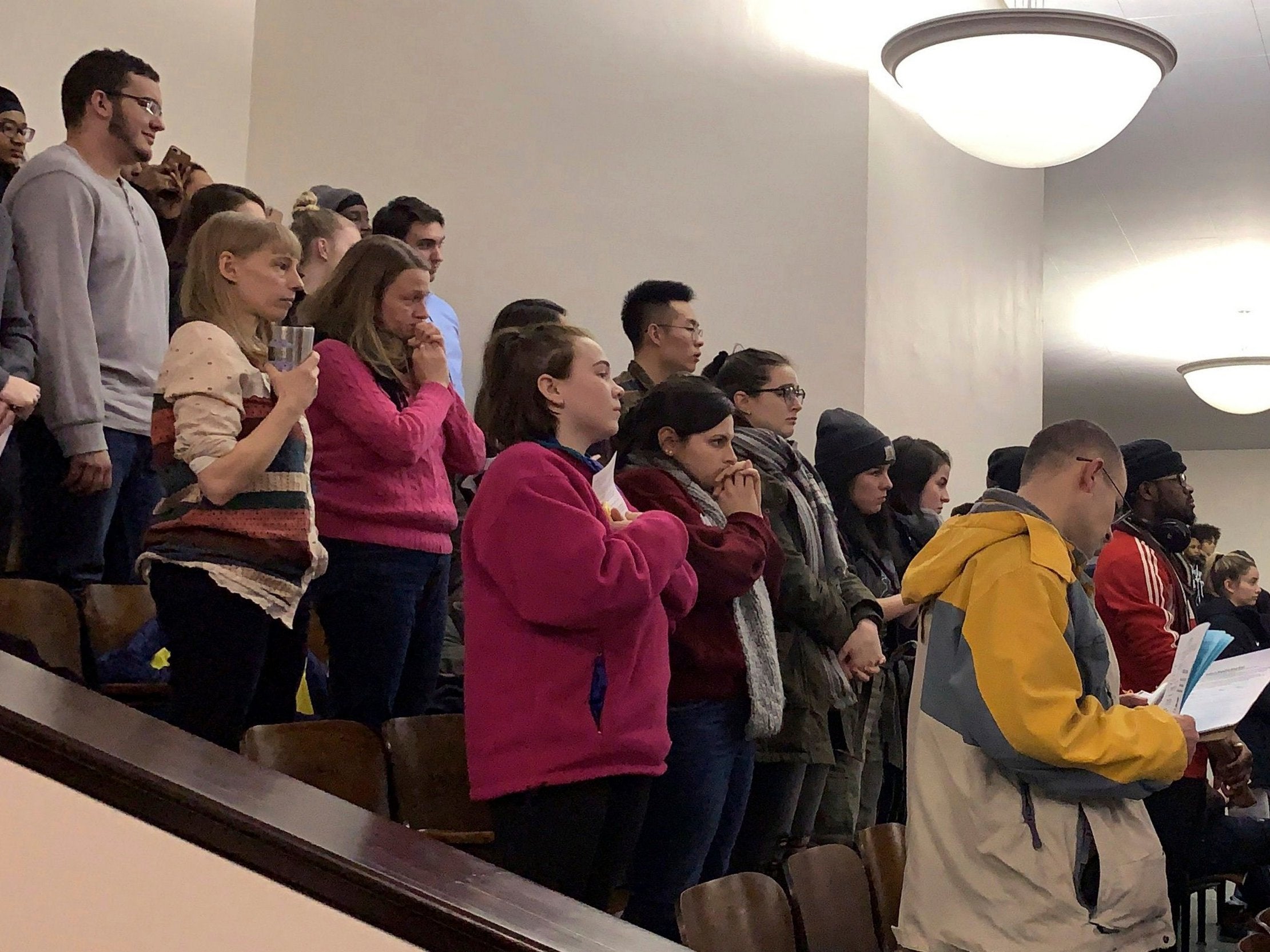 Members of the public fill pack out seats at a school board meeting at East Middle School, Binghamton, New York. The community converged to demand answers after reports four girls were strip-searched by the school because they seemed 'giddy'.