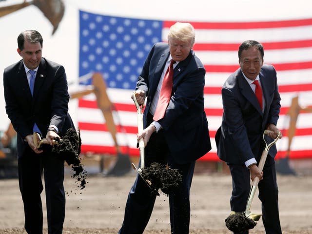 Donald Trump, centre, Wisconsin governor Scott Walker, left, and Foxconn chairman Terry Gou participate in a groundbreaking event for the new company's facility in Mount Pleasant in June 2018