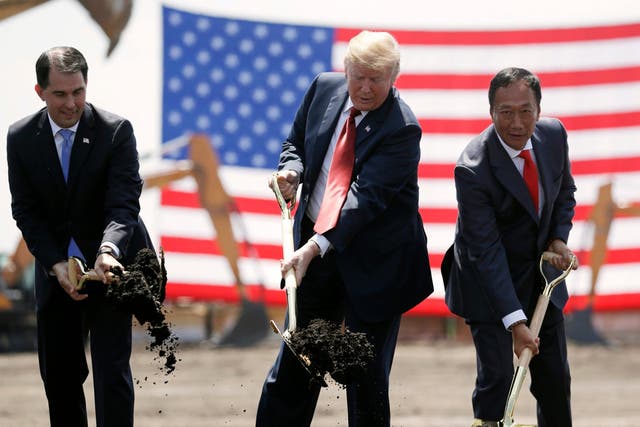 Donald Trump, centre, Wisconsin governor Scott Walker, left, and Foxconn chairman Terry Gou participate in a groundbreaking event for the new company's facility in Mount Pleasant in June 2018