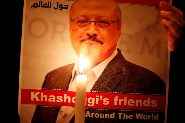 A demonstrator holds a poster with a picture of Saudi journalist Jamal Khashoggi outside the Saudi Arabia consulate in Istanbul