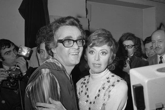 Michel Legrand and Italian singer Caterina Valente embrace after their show a the Olympia concert hall, Paris, in 1972