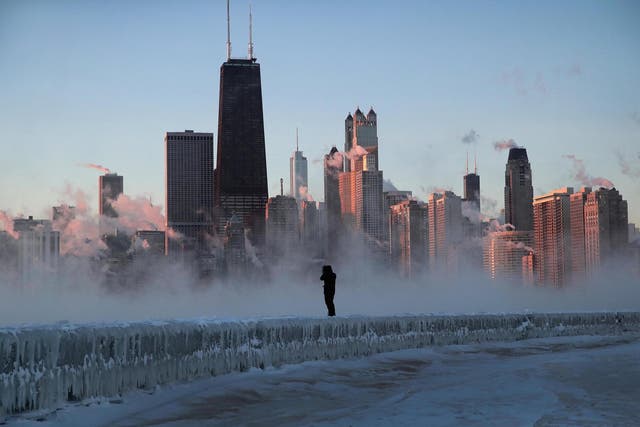A man walks along an ice-covered break-wall along Lake Michigan while temperatures were hovering around -20F (-29C) on 31 January, 2019 in Chicago, Illinois.