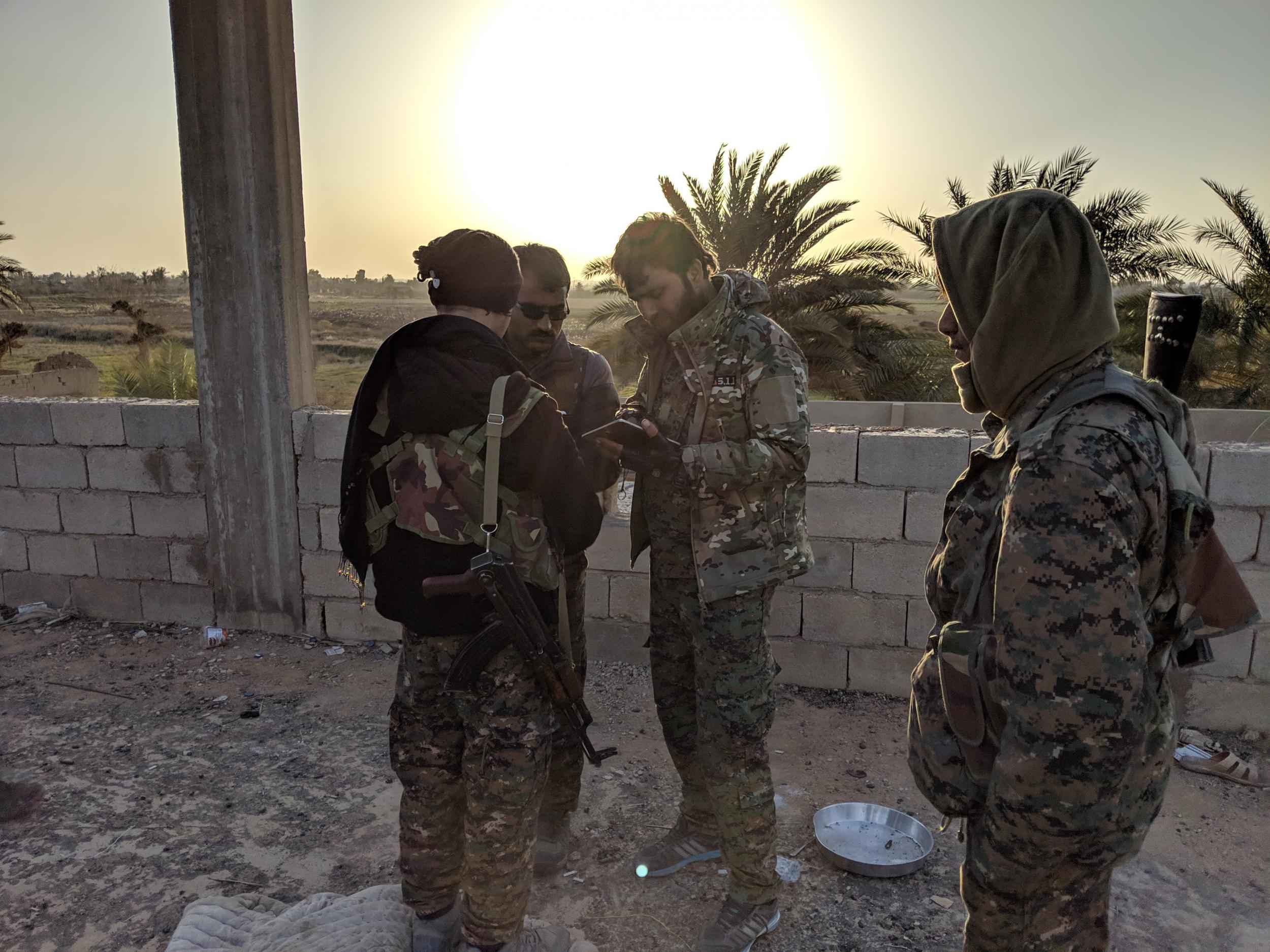 SDF fighters gather near the frontline against Isis in the village of Baghouz Tahtani, eaastern Syria.