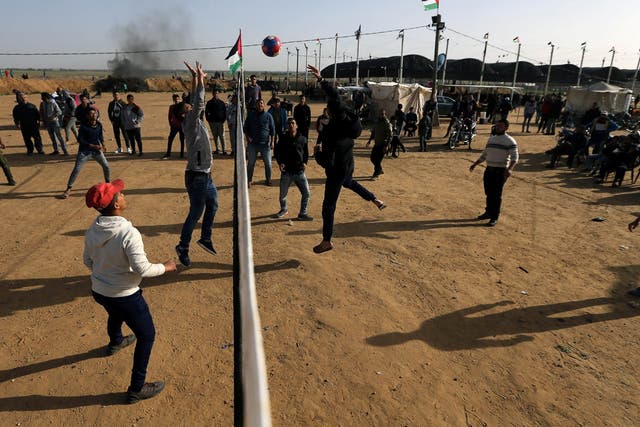 Palestinians play volleyball during a protest near the Israel-Gaza border fence today