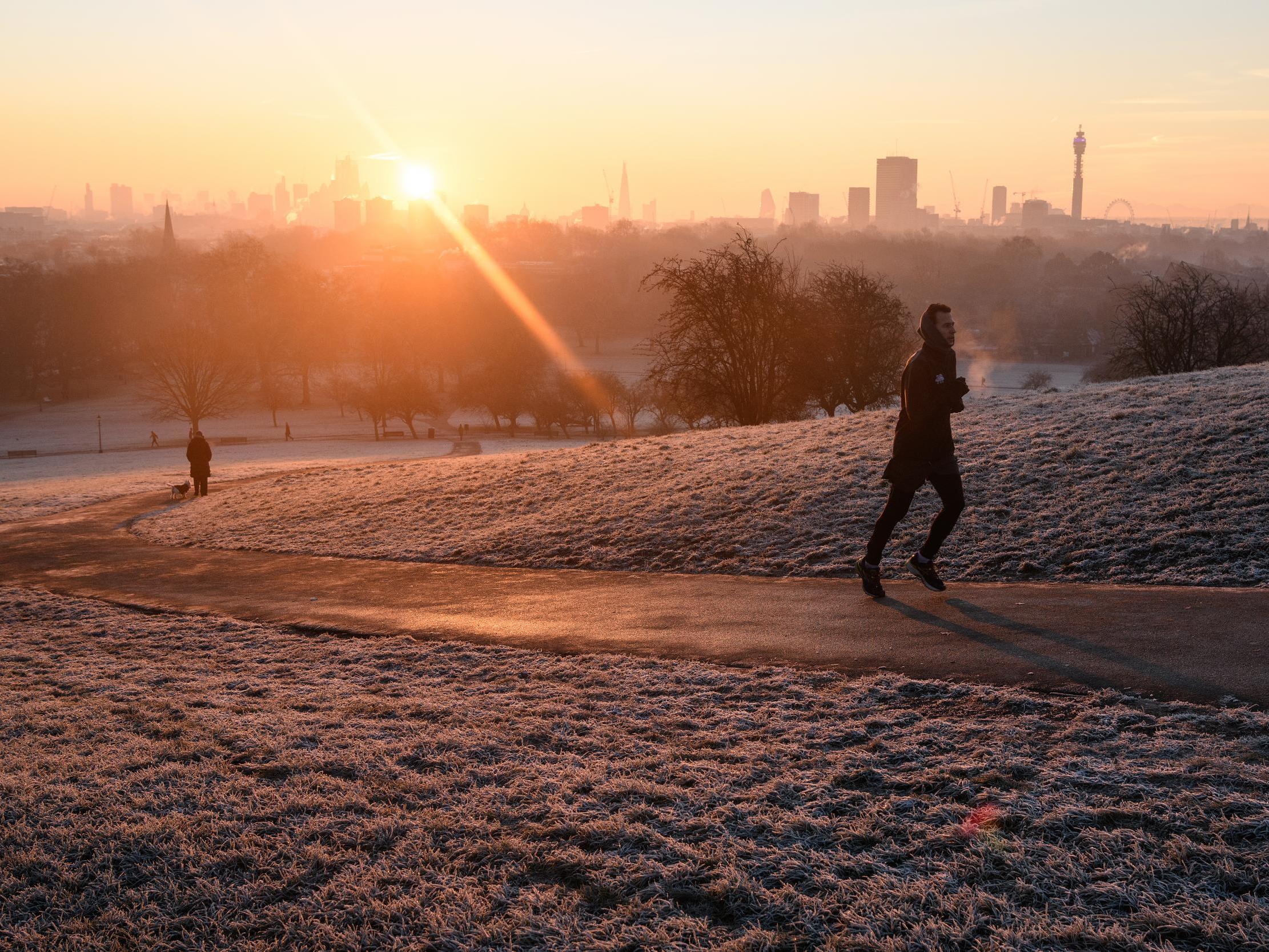 Some people in the UK are dedicated to keeping fit whatever the weather. Pictured: a jogger runs up Primrose Hill, London, UK, as the sun begins to rise on 31 January 2019. The UK has endured the coldest night of the year so far, with temperatures dropping as low as -13c in Scotland.