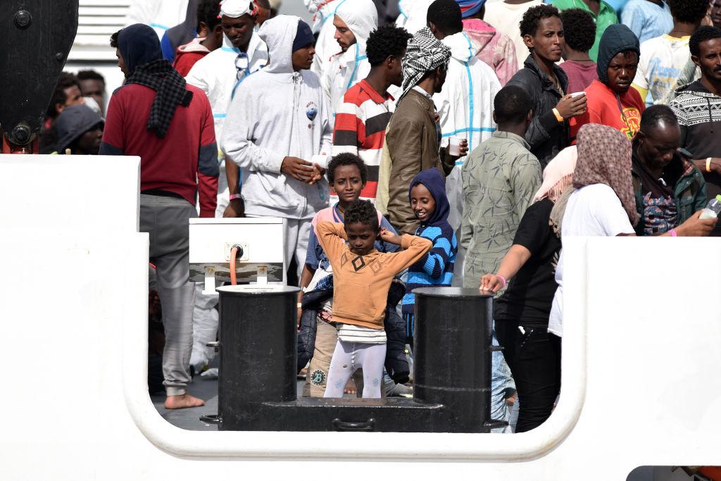 Minors wait to disembark following a rescue operation of migrants and refugees at sea on June 13, 2018 in the port of Catania, Sicily.