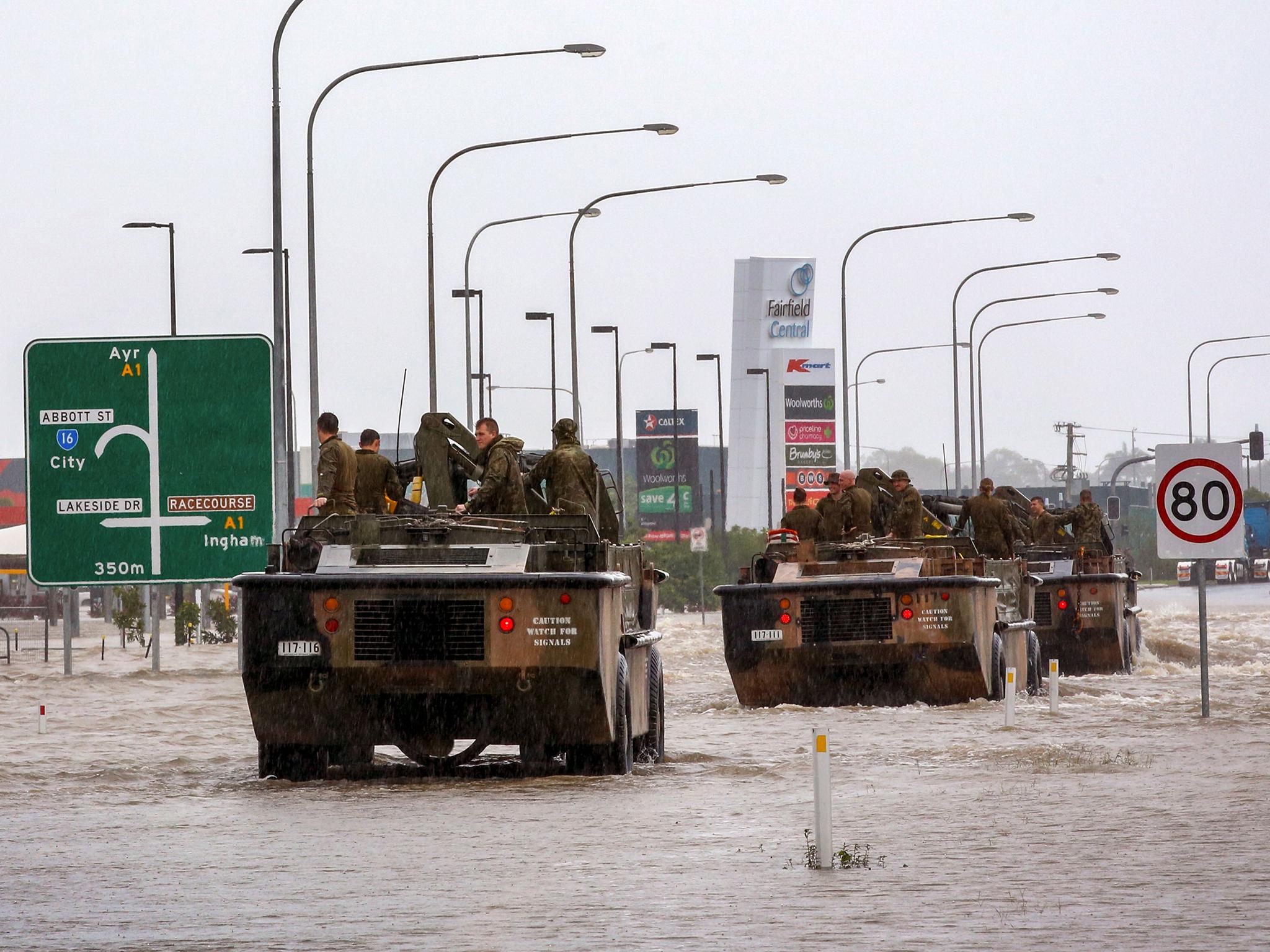 Army vehicles enter Townsville to help evacuate people on February 4