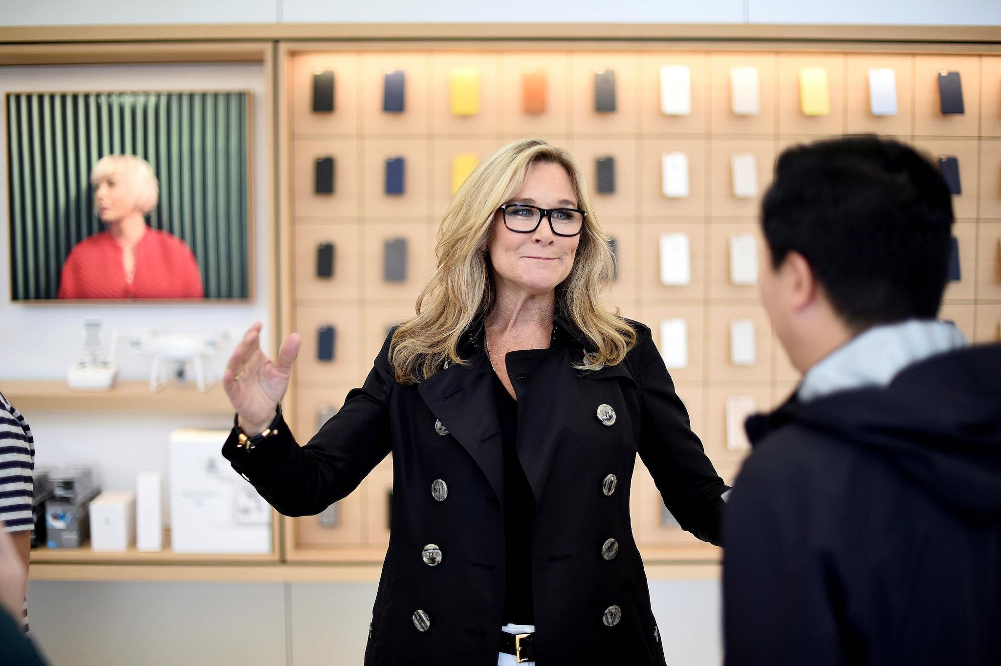 Angela Ahrendts, Apple Inc. senior vice president of retail and online stores, speaks with a worker at Apple's new retail store during a media preview in San Francisco, California