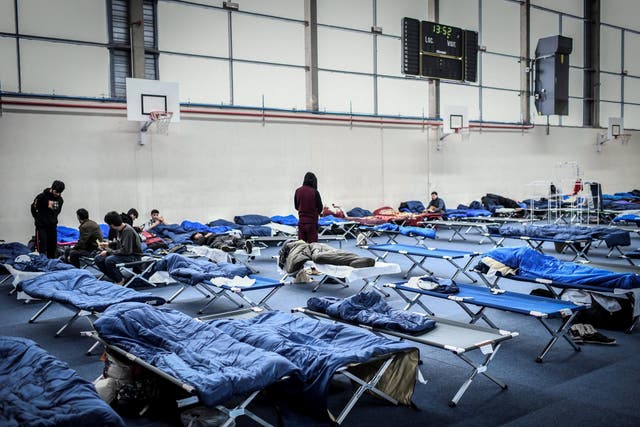 Migrants stay at the Jean-Bouin gymnasium, western Paris, which has been requisitionned to welcome 150 migrants, on January 31, 2019 /