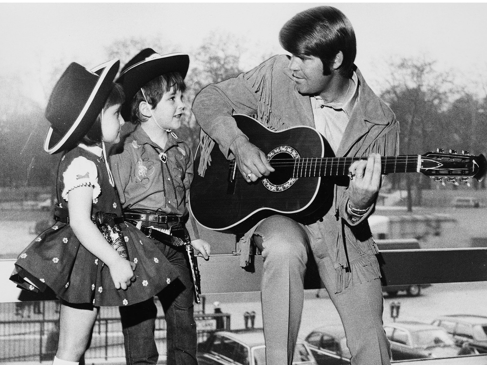 Cowboy song: Glen Campbell serenades two young fans (Getty)