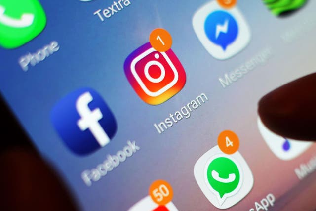 The Instagram, Facebook and WhatsApp icons are displayed on a mobile phone screen