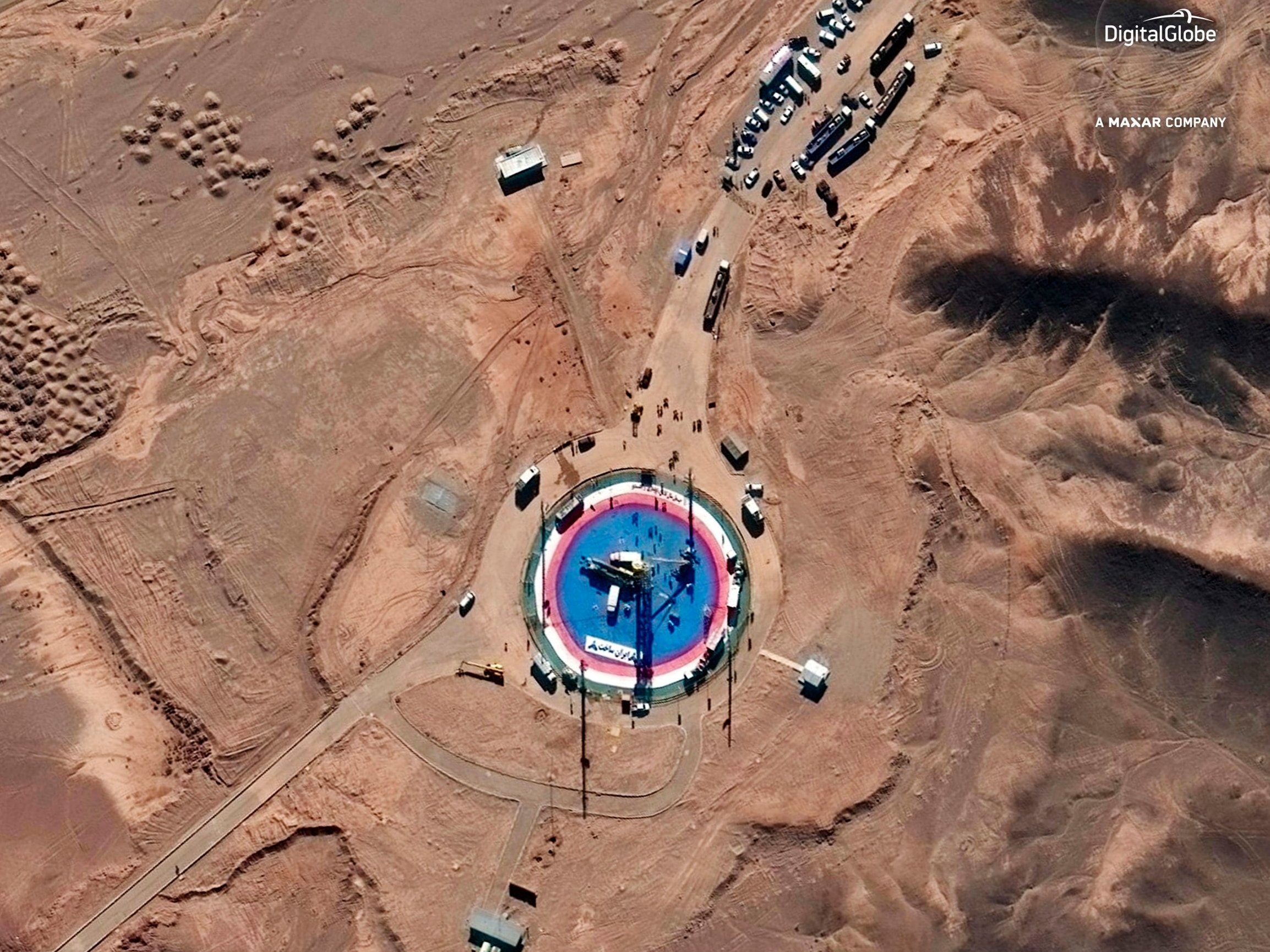 Before: a satellite image shows a rocket on a launch pad and activity at the Imam Khomeini Spaceport in Iran’s Semnan province (DigitalGlobe/Maxar/AP)