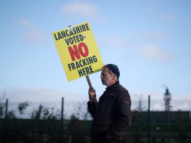 A protester stands outside Cuadrilla's Preston Road fracking site near Blackpool