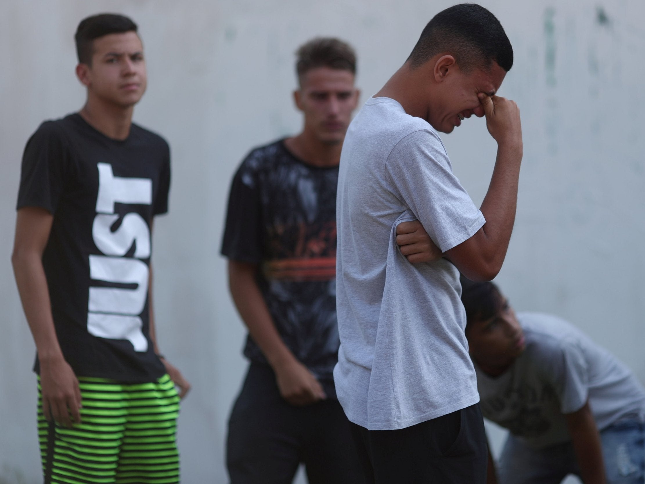 People wait for information outside Flamengo’s training complex (Reuters)