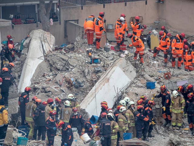 Rescue workers at the site of the collapsed building in Istanbul