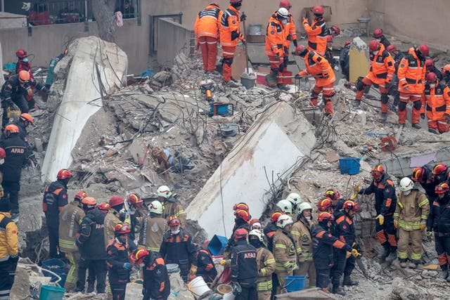 Rescue workers at the site of the collapsed building in Istanbul