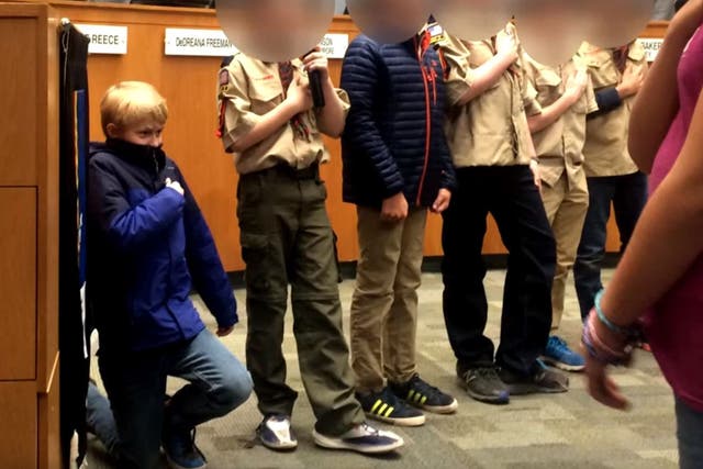 Liam Holmes, 10, dropped to his knees while leading the Pledge of Allegiance at Durham City Council meeting in North Carolina