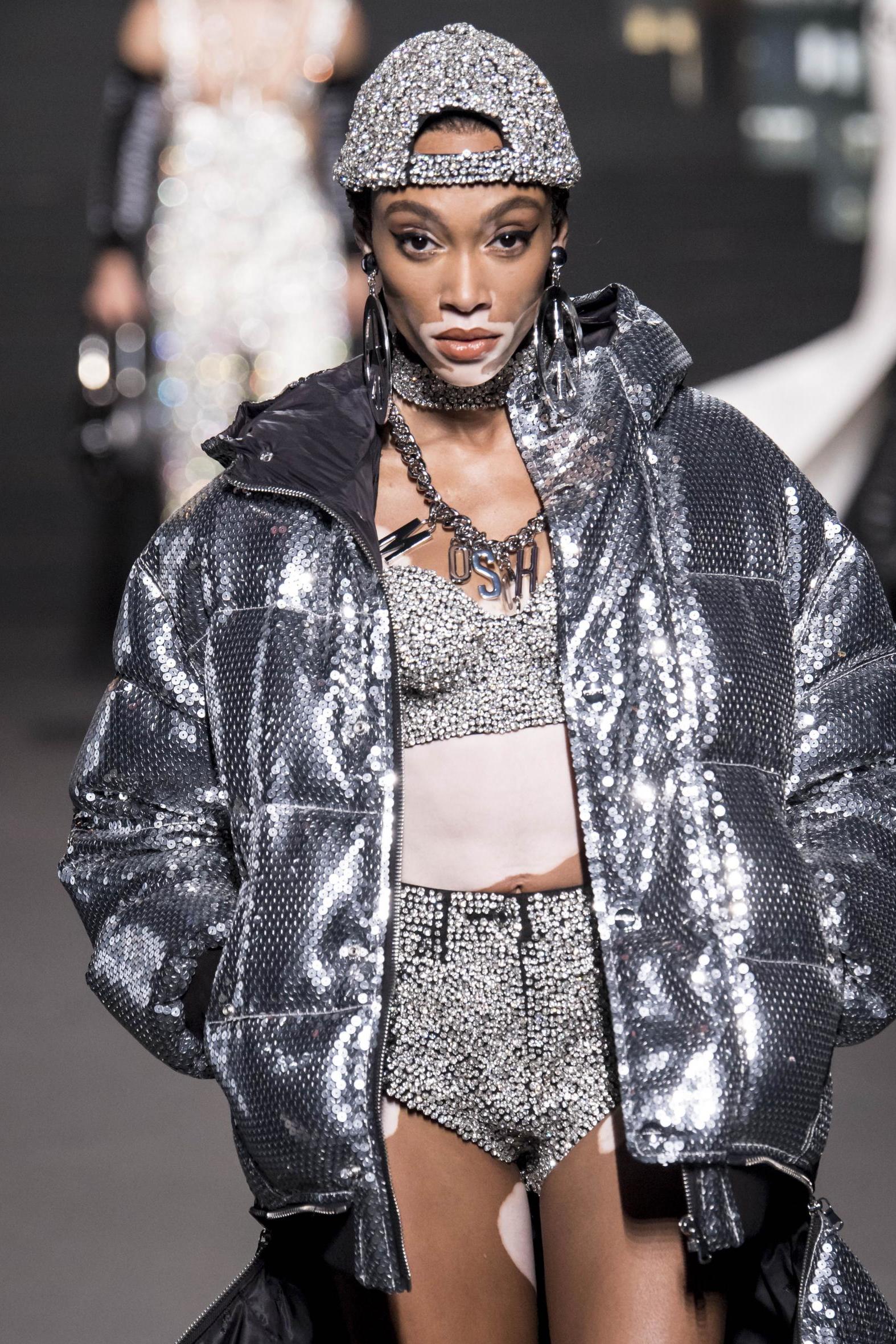 Winnie Harlow wears a sparkling sequin puffer jacket on the Moschino x H&amp;M runway in October 2018.