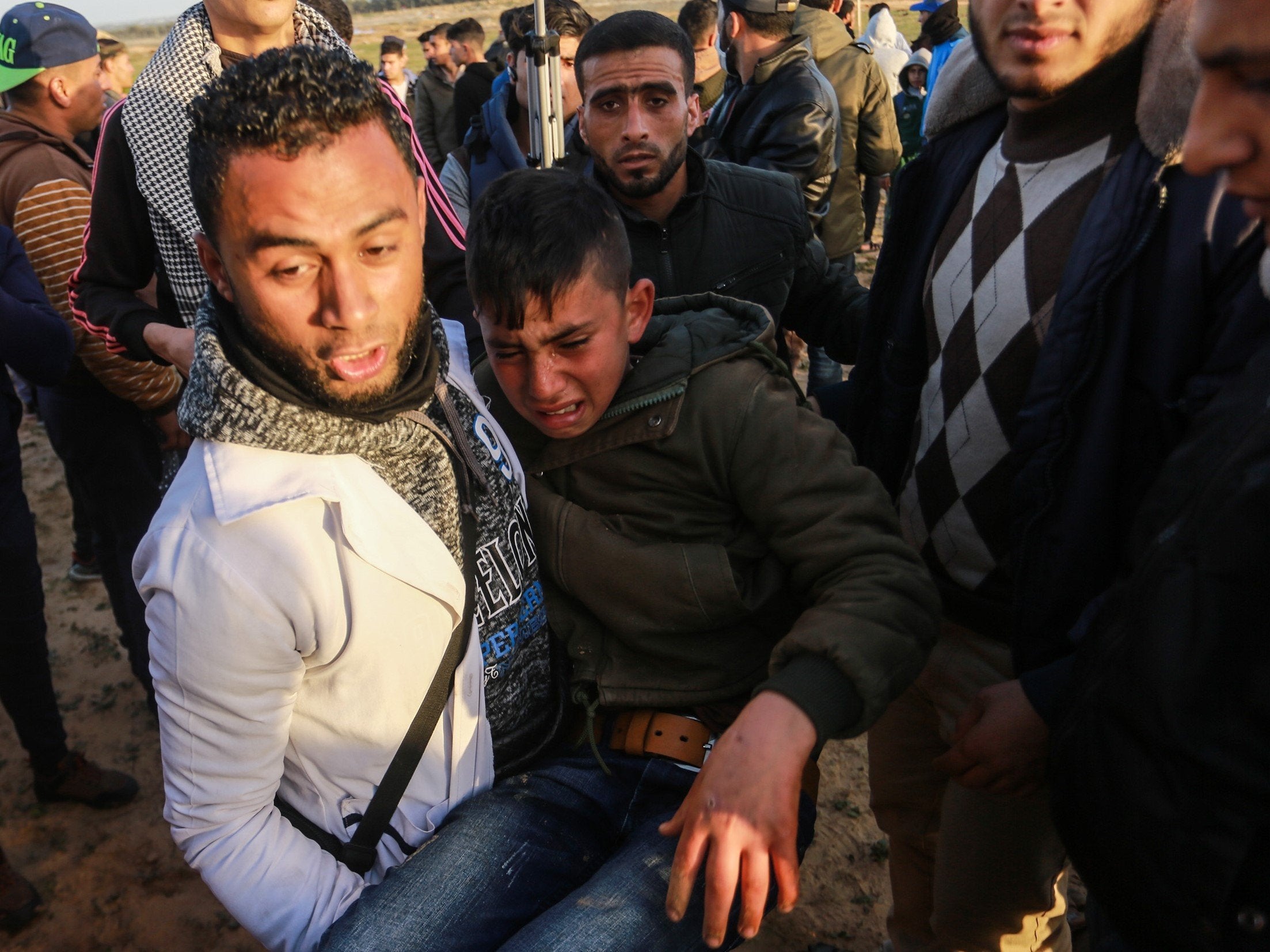 An injured Palestinian carried away during border protest