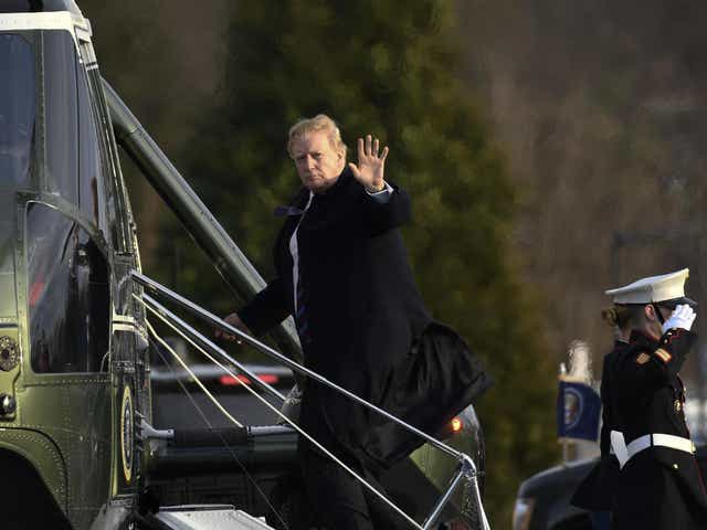 President Donald Trump waves as he walks up the steps of Marine One at Walter Reed National Military Medical Center in Bethesda, Friday 8 February 2019, after having his annual physical.