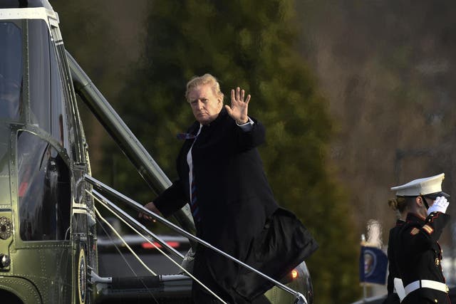 President Donald Trump waves as he walks up the steps of Marine One at Walter Reed National Military Medical Center in Bethesda, Friday 8 February 2019, after having his annual physical.