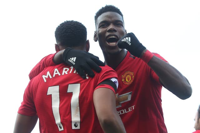 Anthony Martial of Manchester United celebrates scoring with Paul Pogba