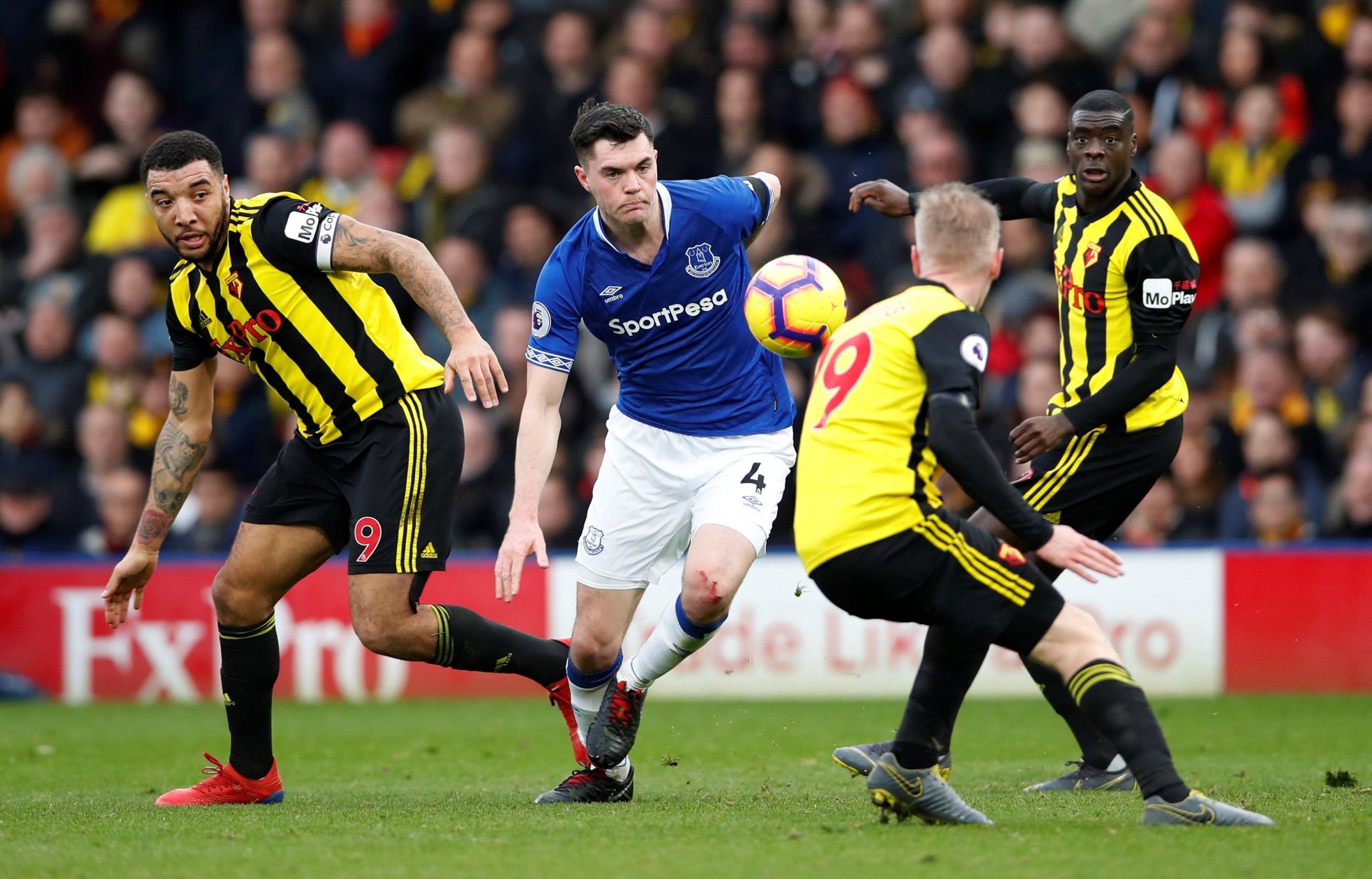 Michael Keane battles for the ball against three Watford players (Reuters)