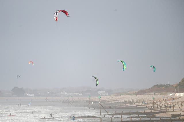 Kitesurfers take to the sea in West Sussex as Storm Erik batters the UK with winds of up to 75mph
