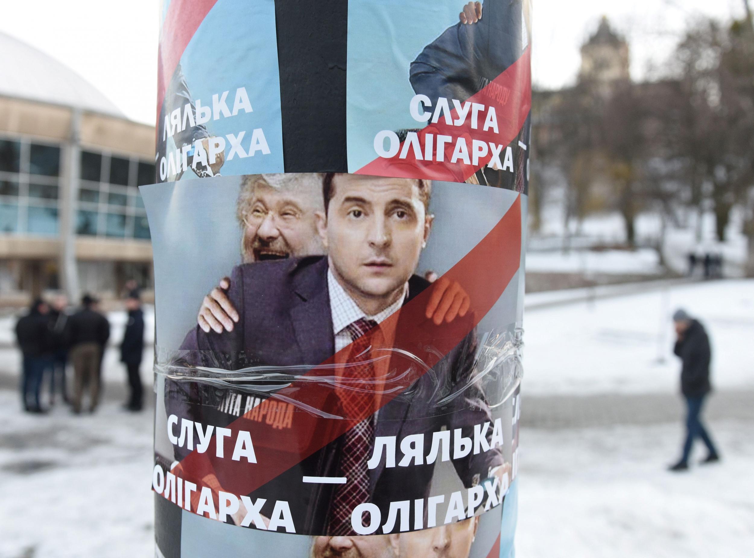 Vladimir Zelensky and oligarch Ihor Kolomoisky appear on a campaign poster