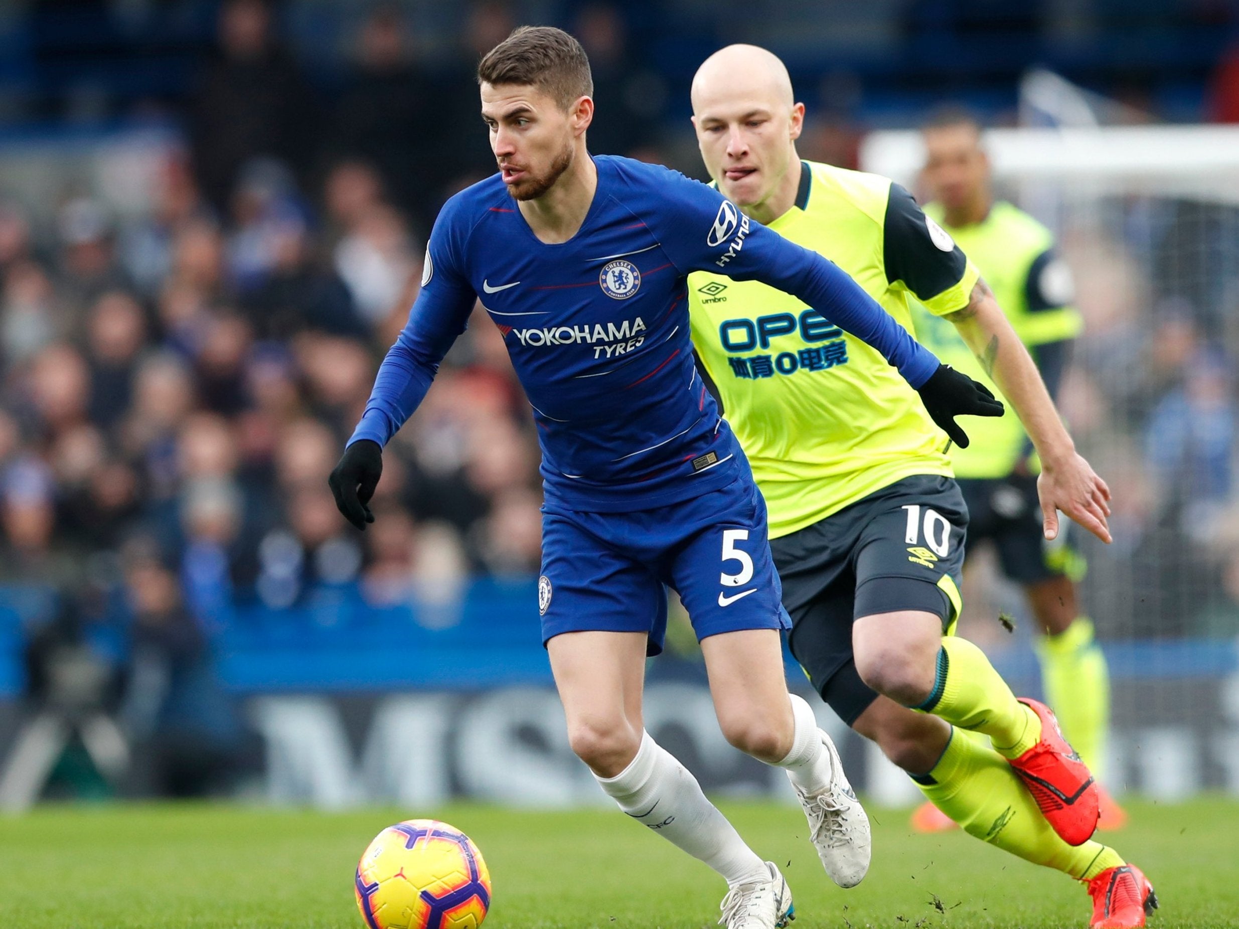 Chelsea's Jorginho and Huddersfield Town's Aaron Mooy challenge for the ball