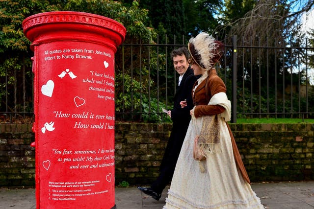 Actors from the Keats Museum walk past one of the adorned boxes