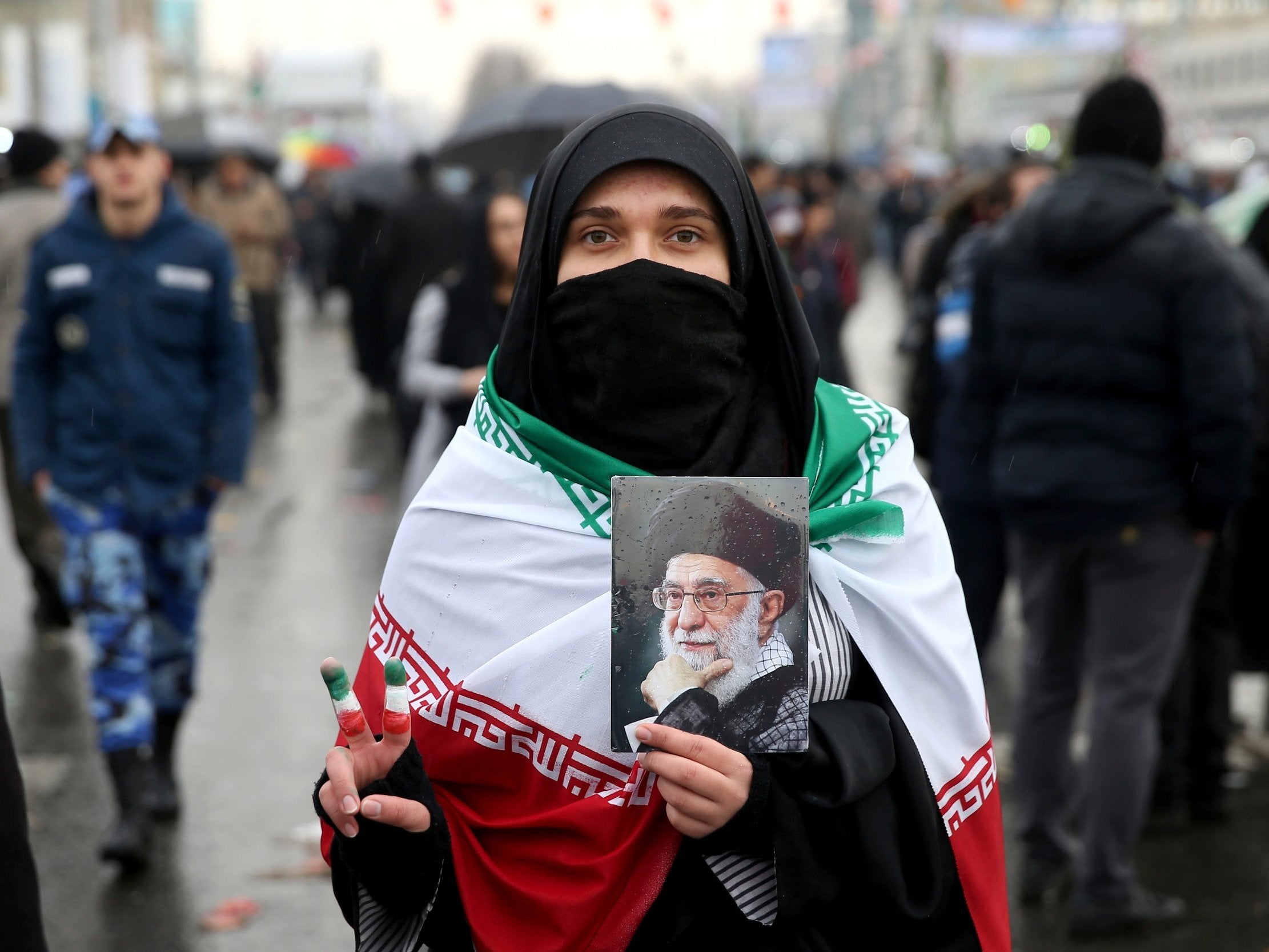 An Iranian woman holds up a portrait of Iranian Supreme Leader Ayatollah Ali Khamenei in Tehran on Monday