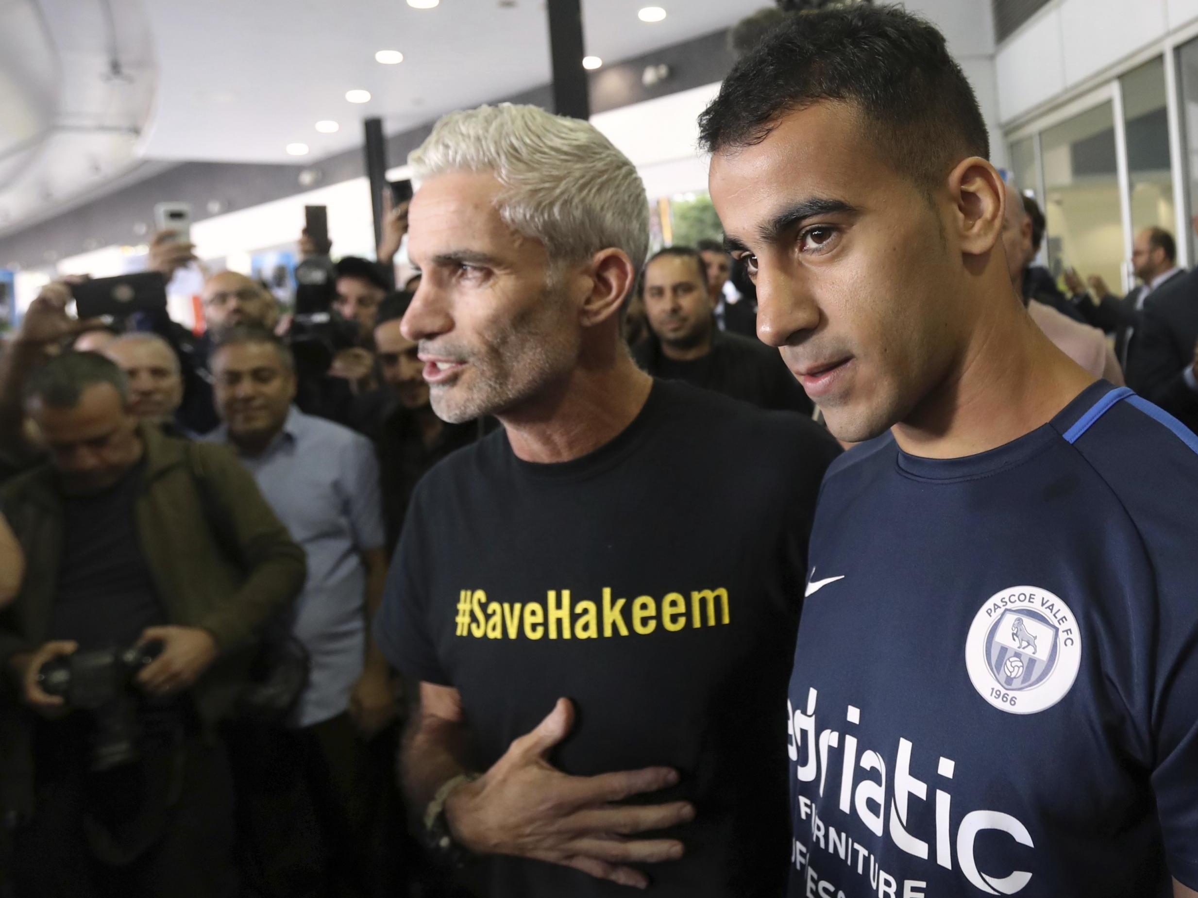 Mr al-Araibi, right, arrives in Melbourne on Tuesday and is greeted by former Australia national team captain Craig Foster