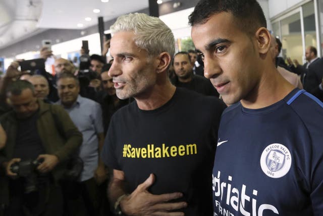 Mr al-Araibi, right, arrives in Melbourne on Tuesday and is greeted by former Australia national team captain Craig Foster