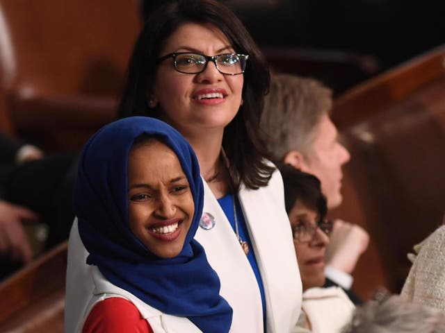 US Representative Ilhan Omar (D-MN) (L) and US Representative from Michigan Rashida Tlaib  (D-MI), dressed in white in tribute to the women's suffrage movement, arrive for the State of the Union address.