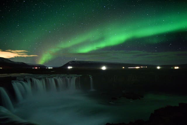 The Northern Lights over Godafoss waterfall in Iceland
