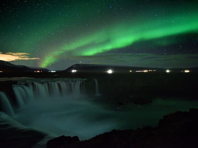 The Northern Lights over Godafoss waterfall in Iceland