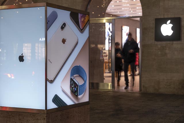 Customers leave the Apple store in Berlin, Germany, 20 December 2018