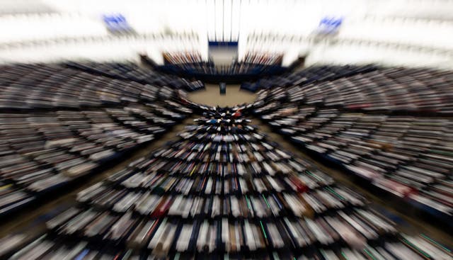 picture taken with a zoom effect shows members of Parliament vote on the EU-Singapore trade agreement  at the European Parliament in Strasbourg, France