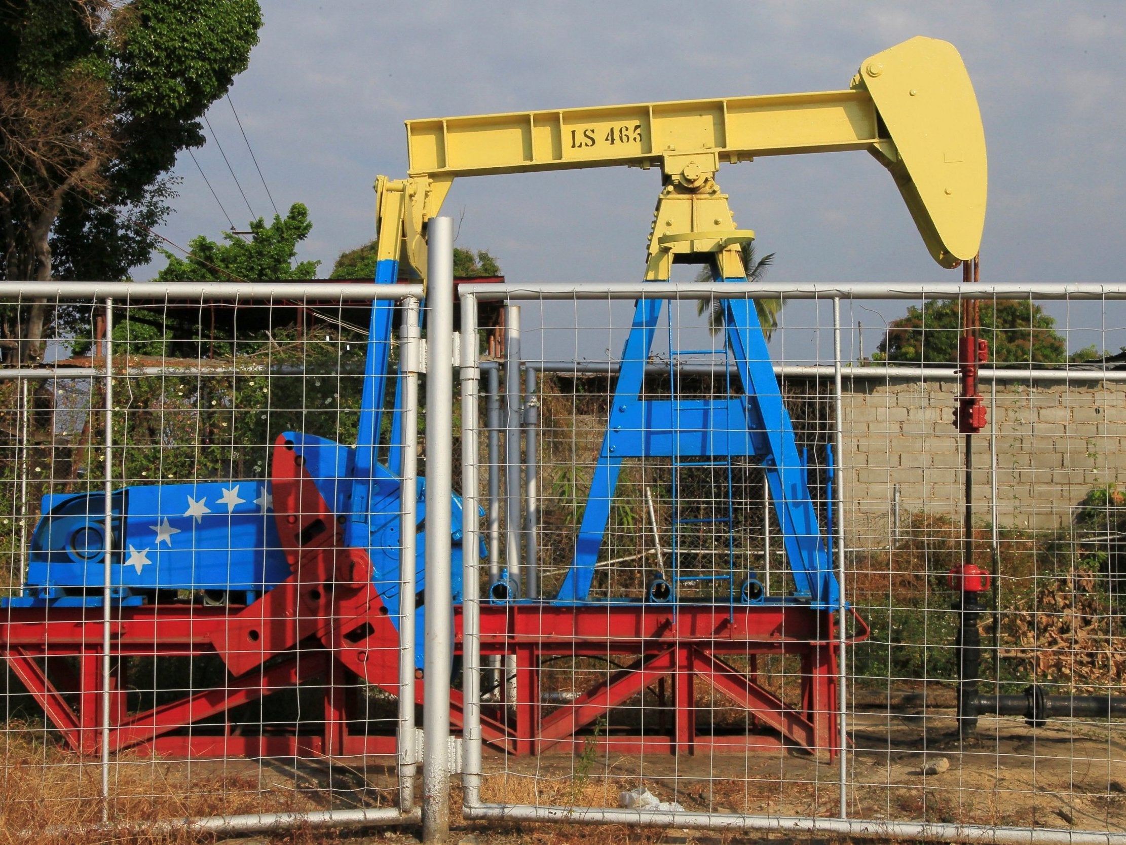 An oil pumpjack painted with the colours of the Venezuelan flag