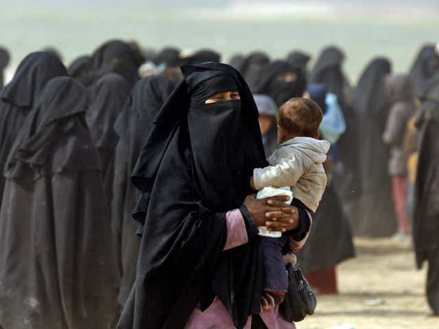 Woman holding her baby among the civilians fleeing Isis holdout of Baghouz on 13 February