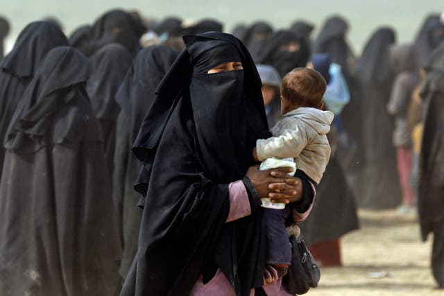 Woman holding her baby among the civilians fleeing Isis holdout of Baghouz on 13 February