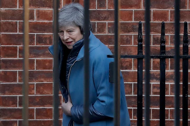 Theresa May leaves from the rear of 10 Downing Street