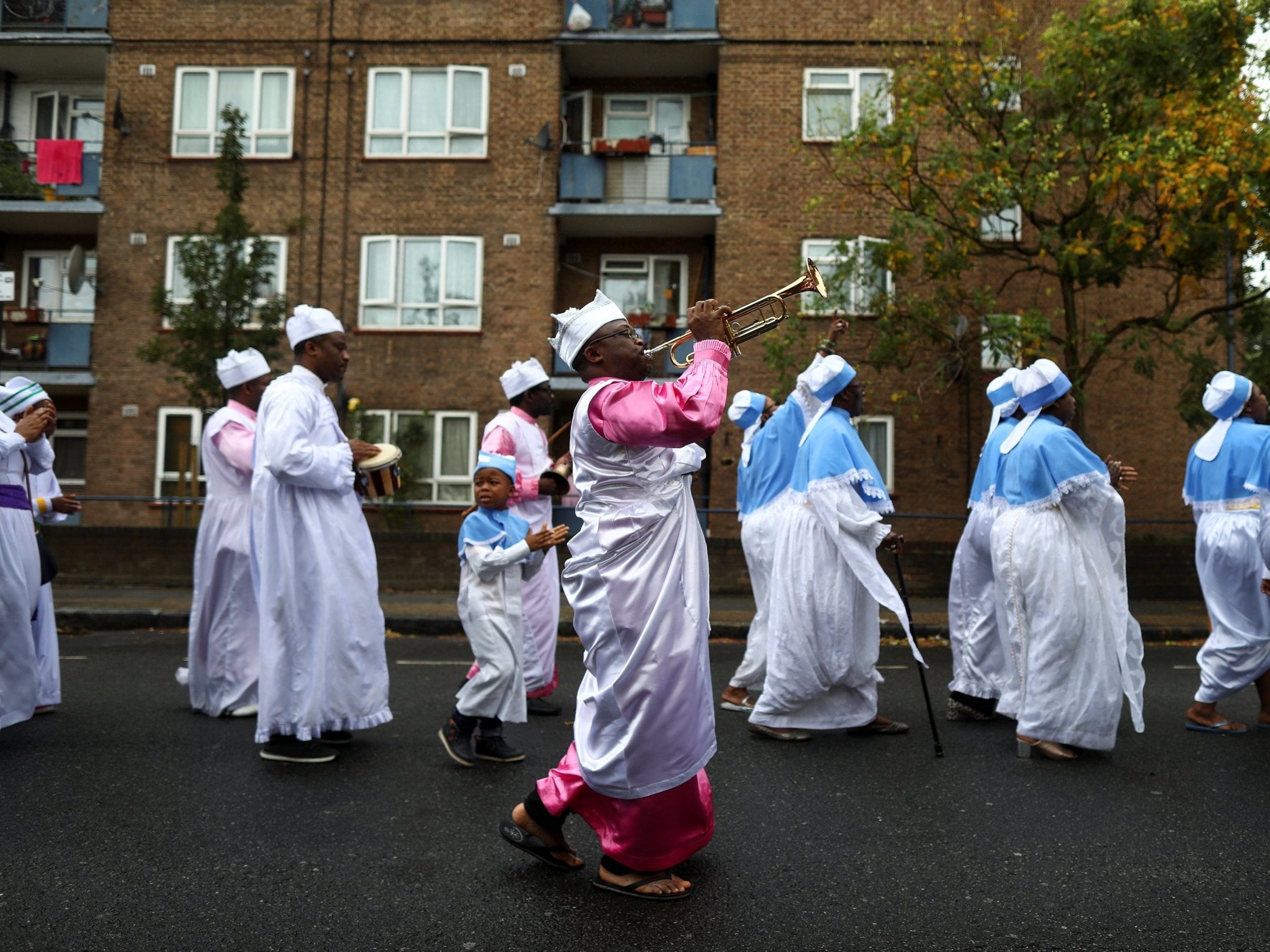 Members of the Eternal Sacred Order of Cherubim & Seraphim parade through the street to celebrate their annual Thanksgiving in Elephant and Castle